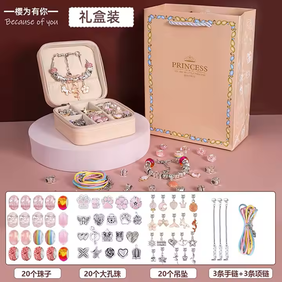 A charm bracelets kit with various components laid out, including beads, charms, elastic strings, and a box for packaging.